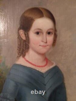 Jeune fille du 19ème siècle en robe bleue, portrait de peinture à l'huile avec une fleur rouge encadrée