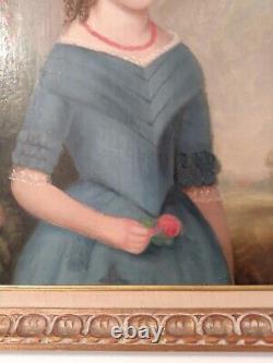 Jeune fille du 19ème siècle en robe bleue, portrait de peinture à l'huile avec une fleur rouge encadrée