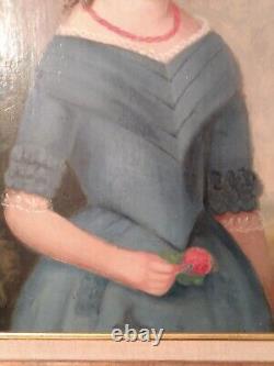 Jeune fille du 19ème siècle en robe bleue, portrait de peinture à l'huile avec une fleur rouge encadrée